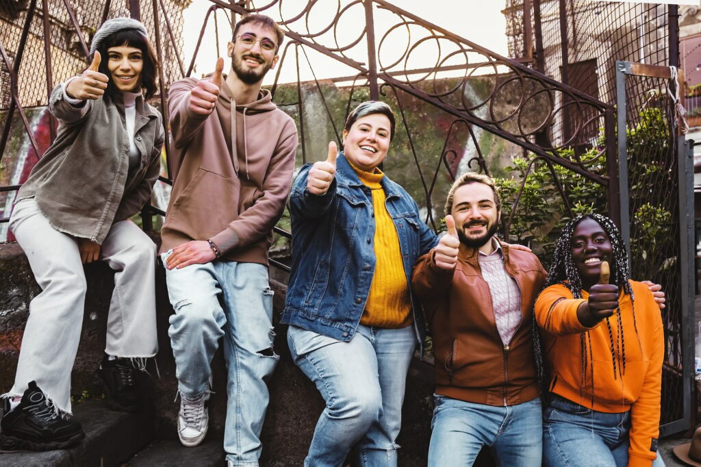 Diverse Group Young People Thumb Up outdoors standing on a stairway